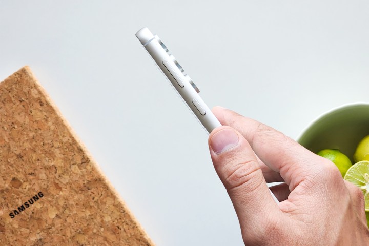 Samsung Galaxy S23 FE Mint Green held from the side showing the aluminum frame.