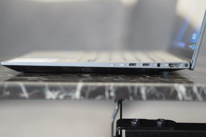 Asus Zenbook 14X OLED side view showing ports and lid.