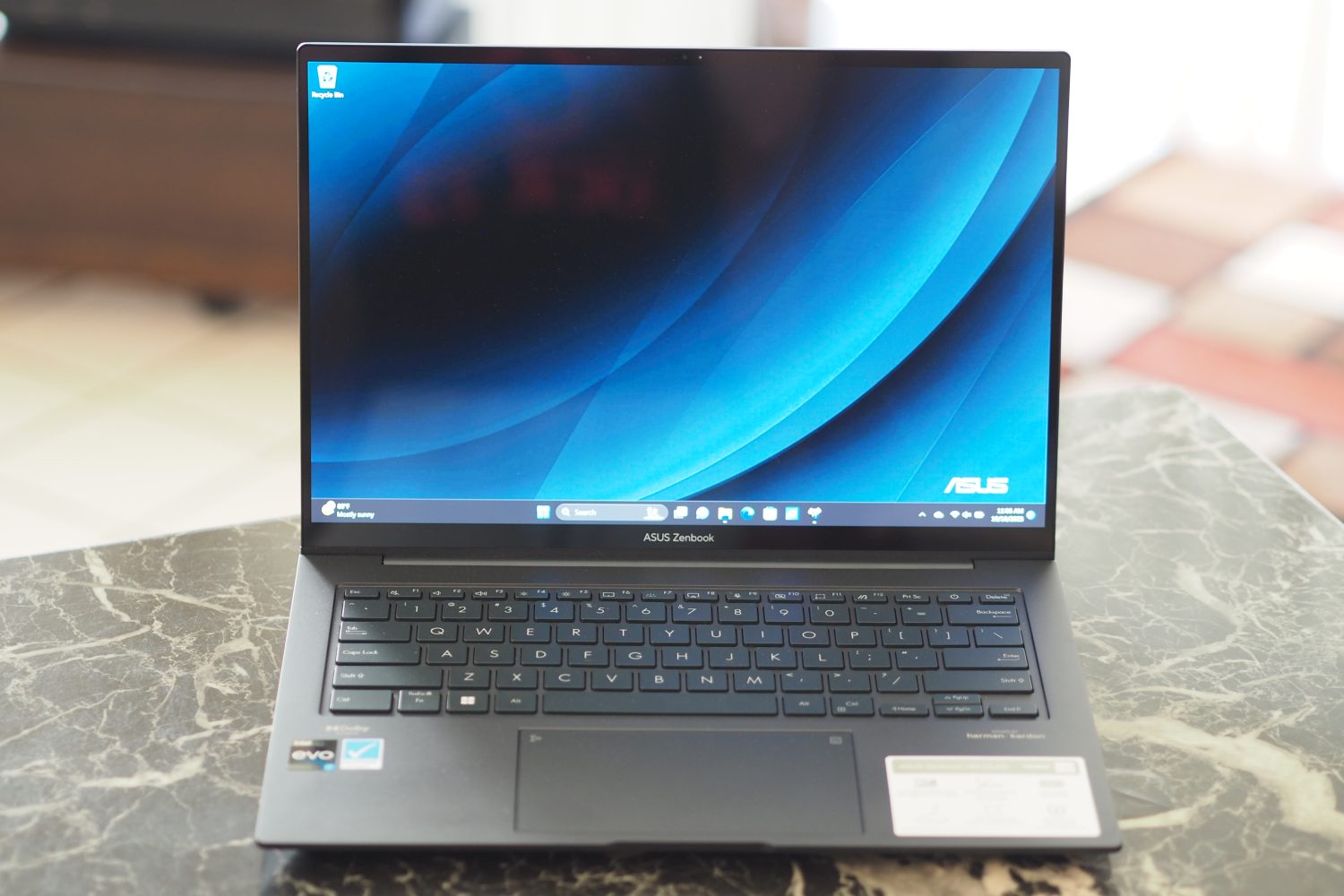 Asus Zenbook 14X front view showing display and keyboard.