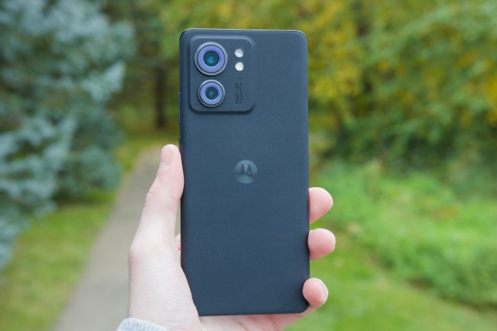 Someone holding the Motorola Edge (2023), showing its backside.
