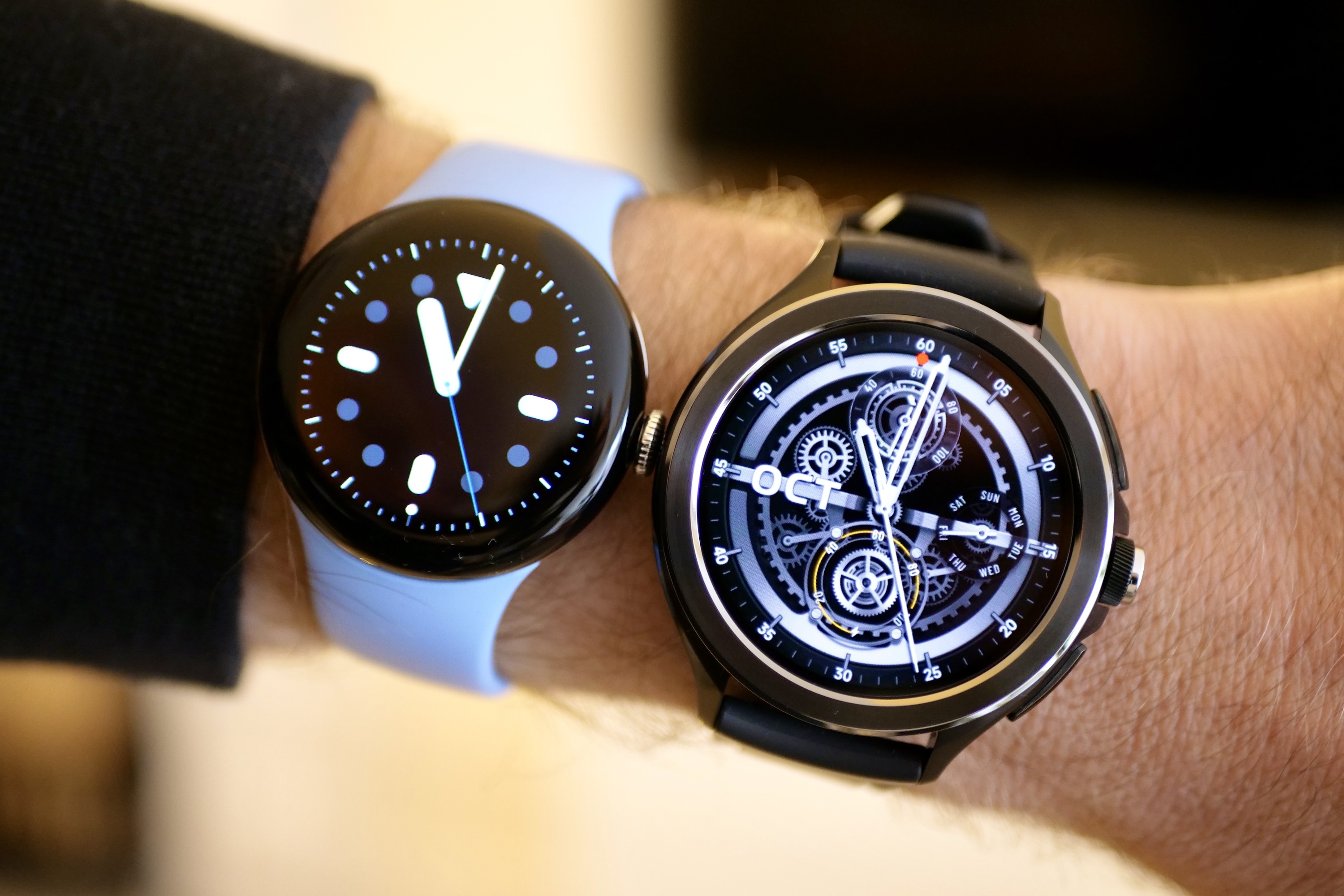 The Xiaomi Watch 2 Pro and the Pixel Watch 2 on a person's wrist.